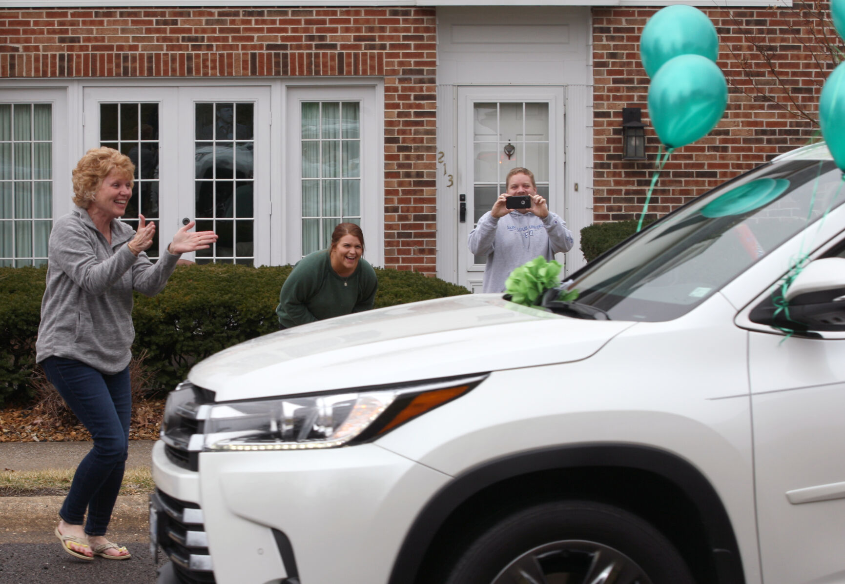 Kim Strubberg rushes to greet parade participants